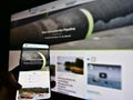 Person holding mobile phone with website of offshore natural gas pipeline project Nord Stream 2.