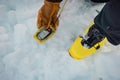 Person holding a modern avalanche beacon in his hands. Off piste skier displaying avalanche beacon and how to use it. Lavine