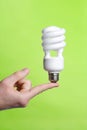 Person holding a modern green light bulb Royalty Free Stock Photo