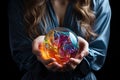 A person holding Multicolored ball with the colors of the LGBT community in hands