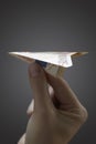 Person holding paper airplane made of 50 euro note close-up of hand