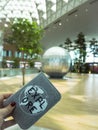 Person holding a passport with inspirational cover