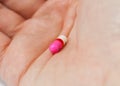 Person holding pill in hand Royalty Free Stock Photo