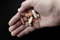 Person holding pills in his hand. Royalty Free Stock Photo