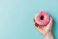 Person Holding Pink Donut With Sprinkles Royalty Free Stock Photo