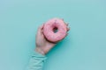 Person Holding Pink Donut With Sprinkles Royalty Free Stock Photo