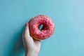 Person Holding Pink Donut With Sprinkles Royalty Free Stock Photo