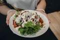 Person holding a plate of healthy food menu with fruits and vegetables Royalty Free Stock Photo