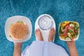 Person Holding Plates Of Burger And Salad Royalty Free Stock Photo