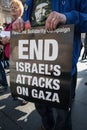 Person holding pro Palestine `End Israel`s Attacks on Gaza` poster at the Free Palestine Rally