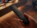 Person Holding Remote Control for Home Cinema System Royalty Free Stock Photo