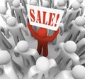 Person Holding Sale Sign in Crowd Advertising Savings Royalty Free Stock Photo