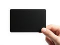 A person holding a sleek black rectangular object against a white background Royalty Free Stock Photo