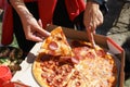 A person is holding a slice pepperoni pizza Royalty Free Stock Photo