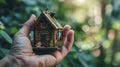 Person Holding Small House, Symbolizing Homeownership and Housing Concept Royalty Free Stock Photo