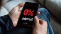Person holding smartphone displaying 0% interest message, engaging content