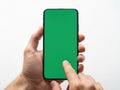 Person holding a smartphone with a green screen in their hand Royalty Free Stock Photo