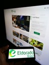 Person holding smartphone with logo of Brazilian pulp manufacturer Eldorado Brasil Celulose S.A. on screen with website.