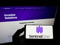 Person holding smartphone with logo of cybersecurity firm Sentinel Labs Inc. (SentinelOne) on screen with website. Royalty Free Stock Photo