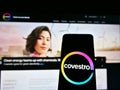 Person holding smartphone with logo of German chemical company Covestro AG on screen in front of business website. Royalty Free Stock Photo