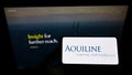 Person holding smartphone with logo of US private equity firm Aquiline Capital Partners LLC on screen in front of website. Royalty Free Stock Photo