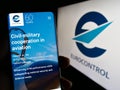 Person holding smartphone with web page of air traffic management organization Eurocontrol on screen with logo.