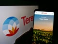 Person holding smartphone with webpage of French agriculture company Tereos S.A. on screen in front of logo.