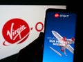 Person holding smartphone with website of American aerospace company Virgin Orbit LLC on screen in front of logo. Royalty Free Stock Photo