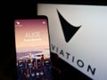 Person holding smartphone with website of electric aircraft company Eviation Aircraft Ltd. on screen with logo.