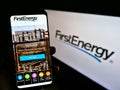 Person holding smartphone with website of US electric utility company FirstEnergy Corp. on screen in front of logo. Royalty Free Stock Photo