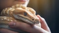 A person holding a snake in their hands, AI