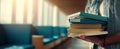 The person holding a stack of books in a modern library setting. AI generated image Royalty Free Stock Photo