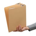 Person holding a stack of manila folders with labels Royalty Free Stock Photo
