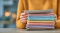 A person is holding a stack of papers, some of which are colorful Royalty Free Stock Photo