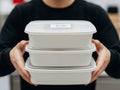 Person holding stack of white containers Royalty Free Stock Photo