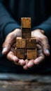 A person holding a stack of wooden blocks in their hands, AI