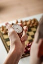 Person Holding Stop Watch Above Chess Board Royalty Free Stock Photo