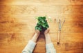 Person holding a strawberry plant on a rustic table Royalty Free Stock Photo