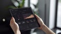 A person holding a tablet with a digital dashboard