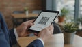 Person holding tablet displaying qr code for contactless payment Royalty Free Stock Photo