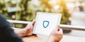 Person holding tablet representing digital security, data protection, and secure network access with a privacy shield icon Royalty Free Stock Photo