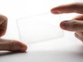 A person holding a thin transparent rectangular object Royalty Free Stock Photo