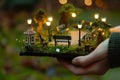 person holding a tiny park with benches and lights Royalty Free Stock Photo