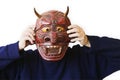 Person Holding Up A Devil Mask Royalty Free Stock Photo