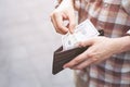 Person holding an wallet in the hands of an man take money Royalty Free Stock Photo