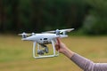 A person holding a white drone in their hand Royalty Free Stock Photo