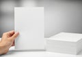 Person holding a white foam board next to a large white foam block Royalty Free Stock Photo