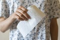 a person holding a white toilet paper roll, standing to the wall, clean personal hygiene, isolated Royalty Free Stock Photo