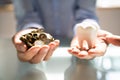 Person Holding White Tooth And Golden Coins