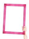 Person Holding Wooden Pink Frame in Hands with Cli Royalty Free Stock Photo